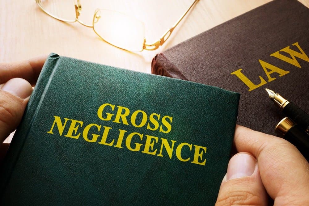 Man holding gross negligence book.