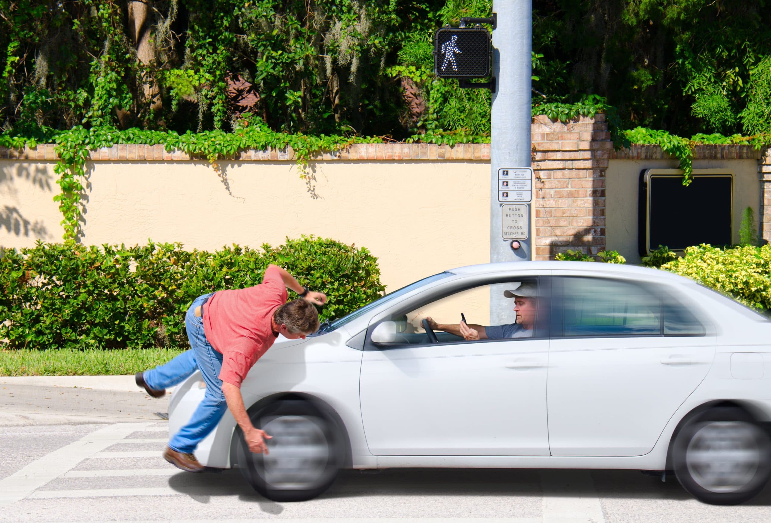 Distracted driver hit a man walking in pedestrian lane.