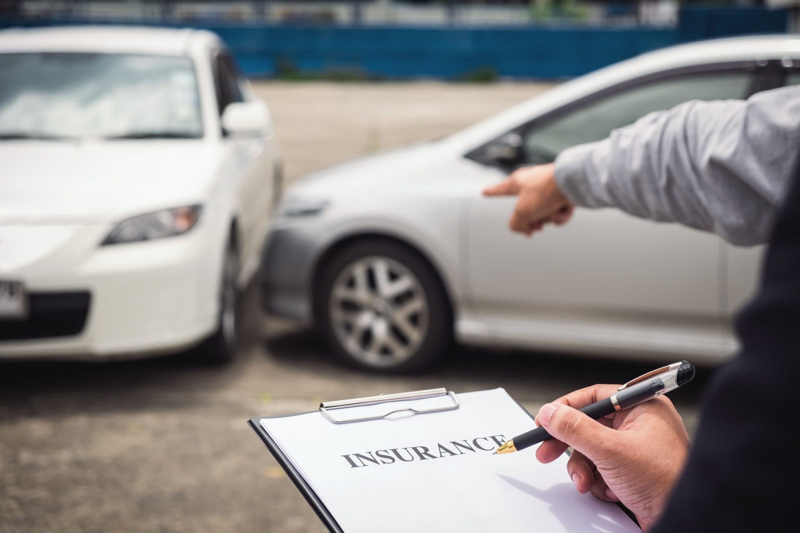 Insurance agent checking the car damage to claim insurance.