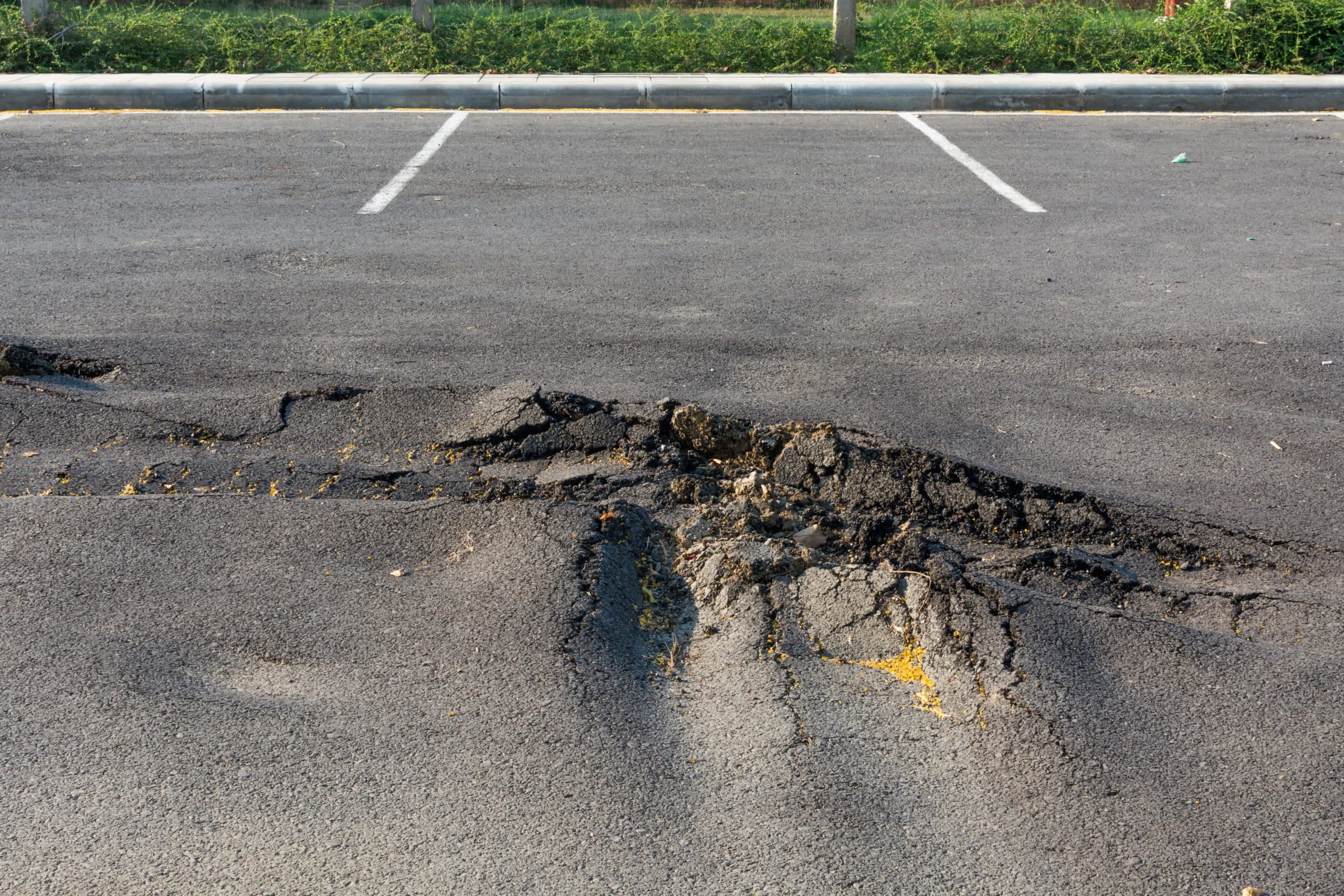 Uneven surface in parking lot may lead to slip and fall.