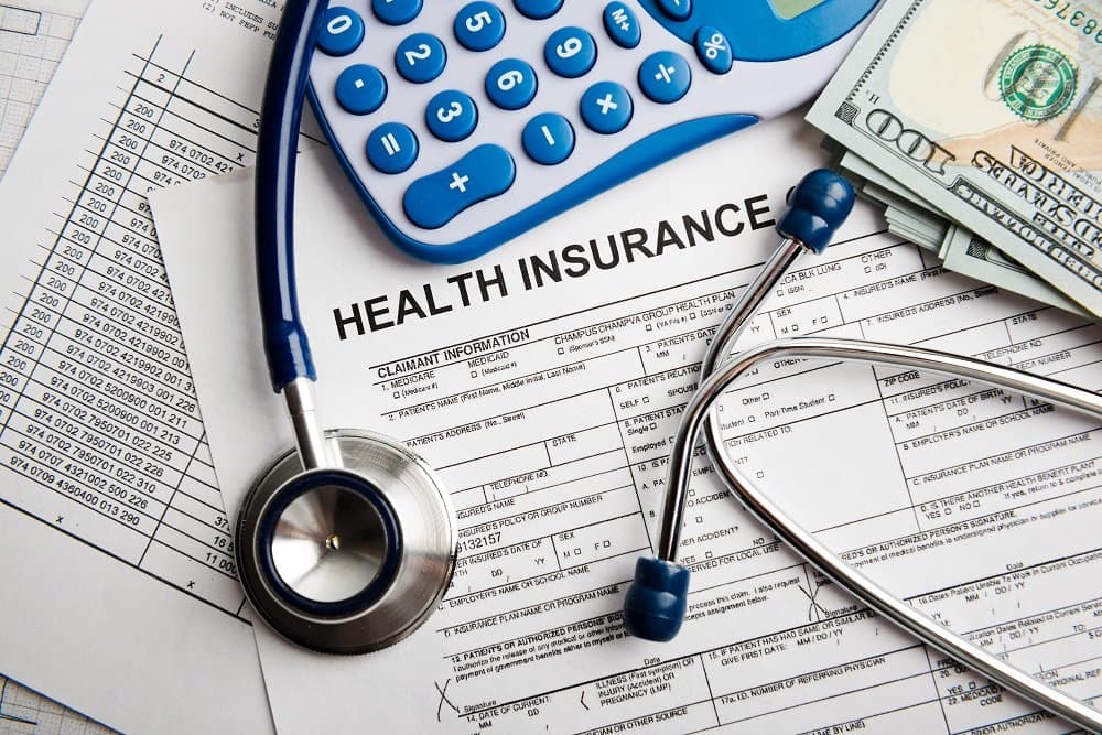 Health insurance application form with banknote and stethoscope concept for life planning.