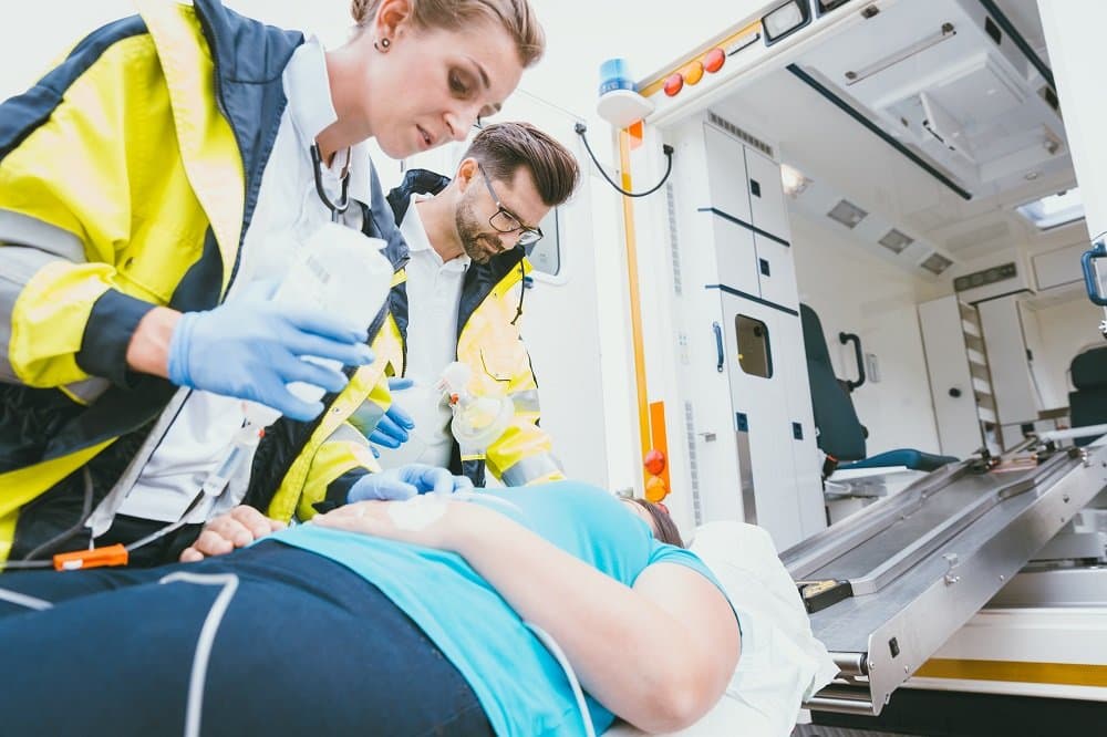 Paramedics rescuing car accident victim.