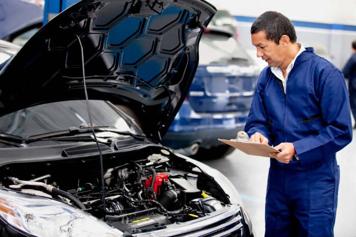 mechanic inspecting car