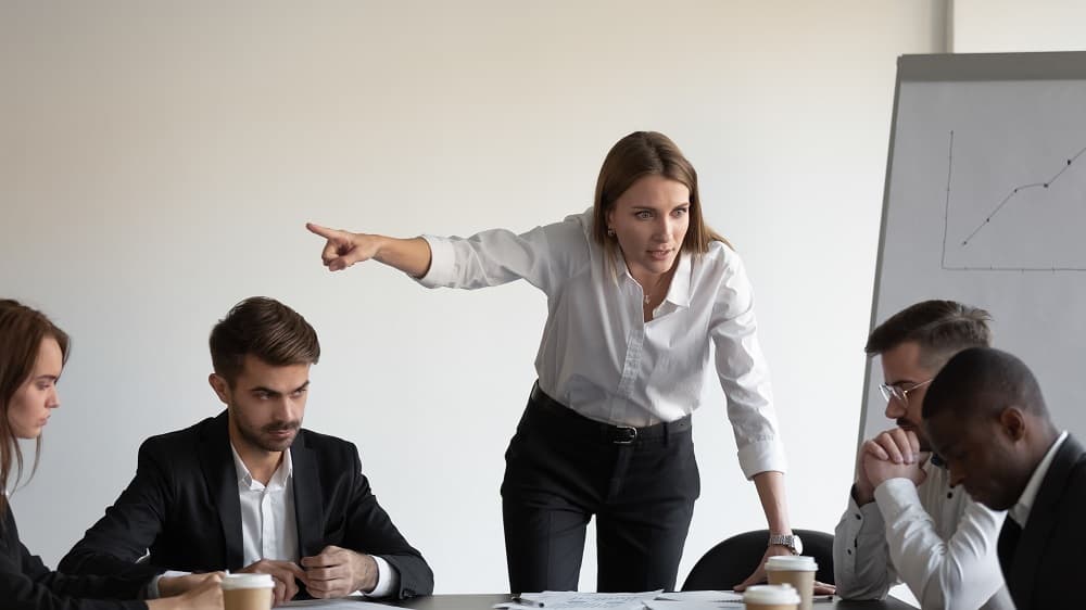 Lady boss firing his colleague showing unfair treatment.