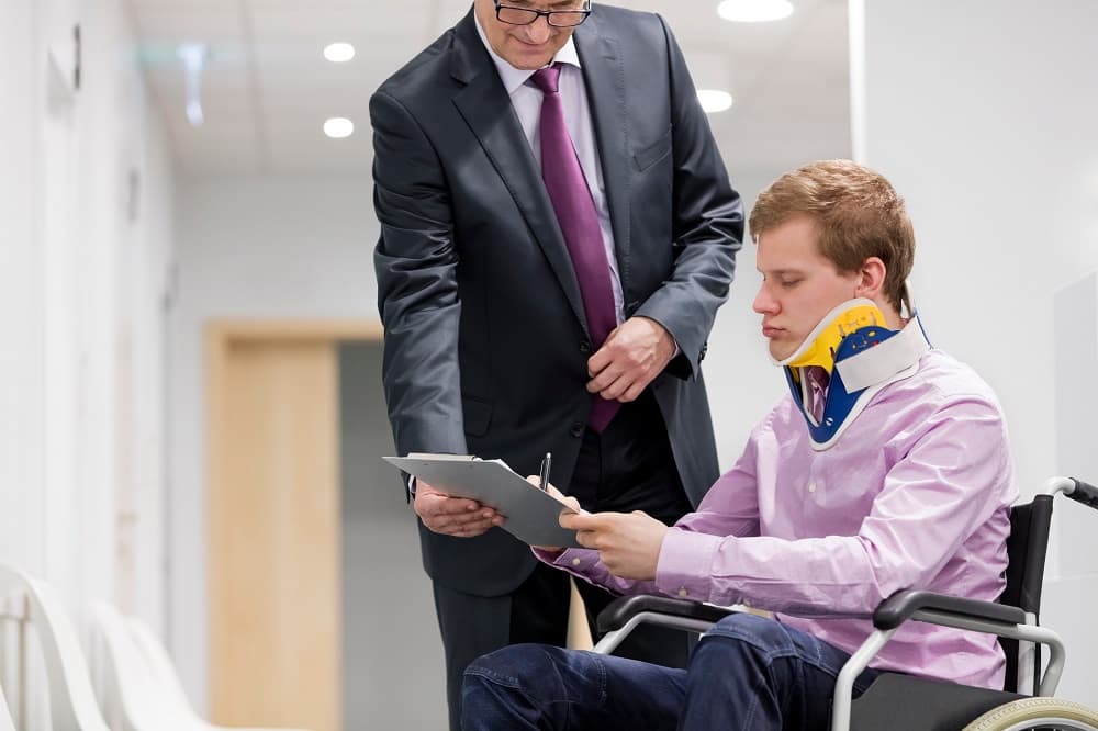 Disabled man reading workers compensation benefits.