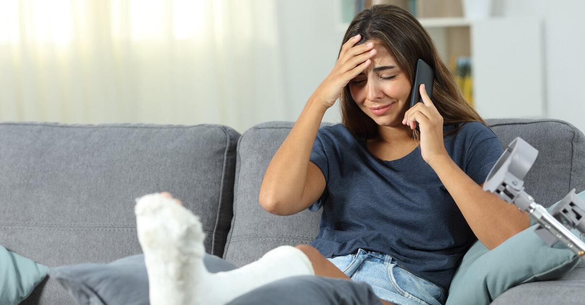 Injured woman crying while talking to phone.