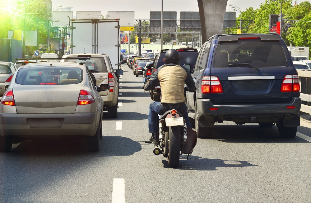 Motorcycle showing lane splitting in the traffic.