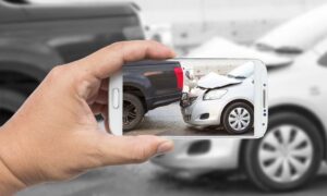 A Colorado Springs car accident lawyer takes a photo of a crash for evidence.