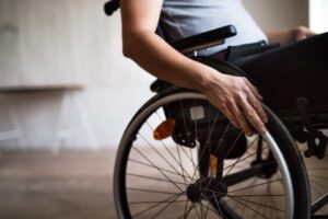 Disabled man sitting on his wheelchair at home.