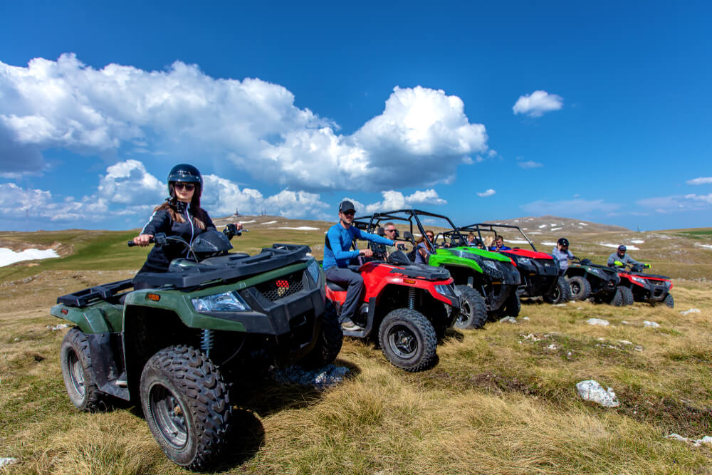 Group of tourists riding ATVs.