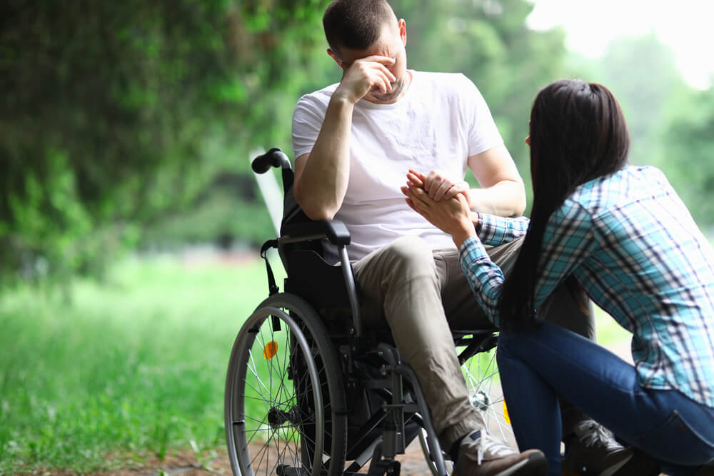 Man on wheelchair is worried about his job loss due to disability.