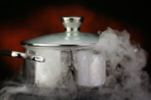 Steam over cooking pot on a red background.