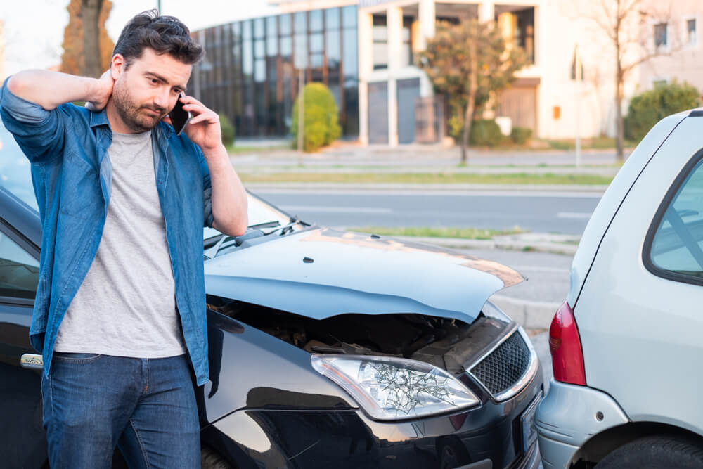 Driver calling for help to report accident in the road.