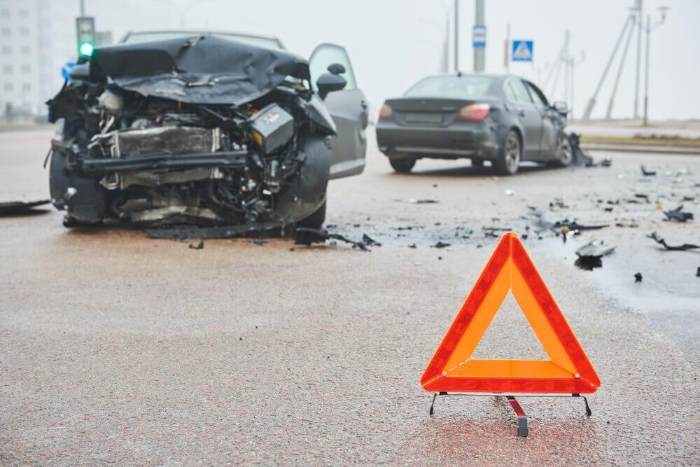 Cars colliding in intersection highway.