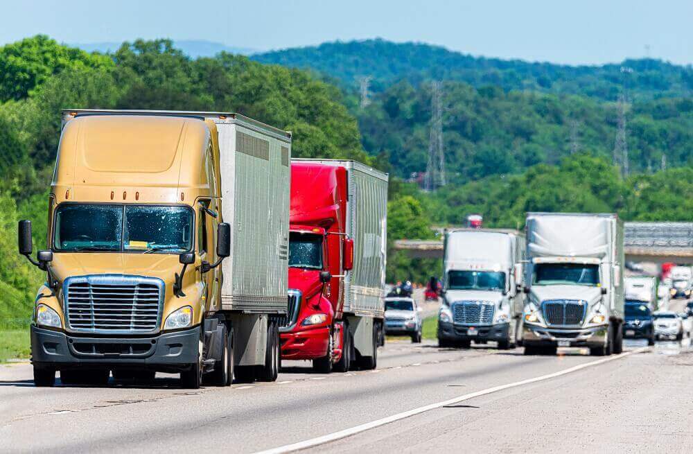 Trucks in convoy interstate highway.