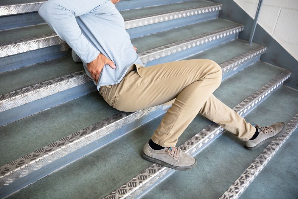 Man suffering back pain from slip and fall.